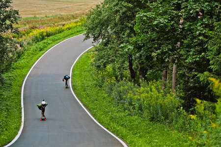 MINSK, BELARUS - AUG 10, 2019: Longboard competitions on the track, Belarus.Longboarding is a type of street skiing that has its roots in surfing. Riding a longboard creates strong emotional sensations, ... Sometimes speed competitions are held.の写真素材