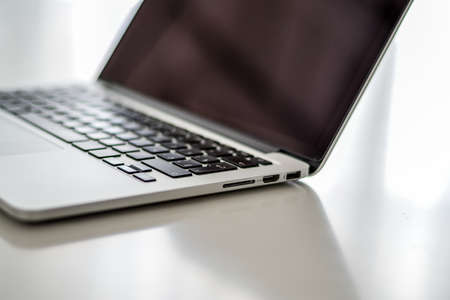 Laptop, telephone, pen on the gray table. Office work. High quality photo