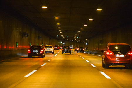 GERMANY - AUGUST 2015: Traffic in the tunnel, yellow lights, lanterns. Cars in a tunnel. High quality photoのeditorial素材