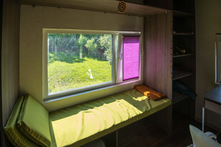 MINSK. BELARUS - May 2016: Interior of a room with a sofa by the window, light green sofa by the window overlooking a green grass. High quality photoのeditorial素材