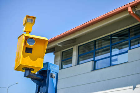 POLAND. WARSAW - MAY 2016: Yellow speed camera on the background of the building with windows and blue sky. High quality photoのeditorial素材