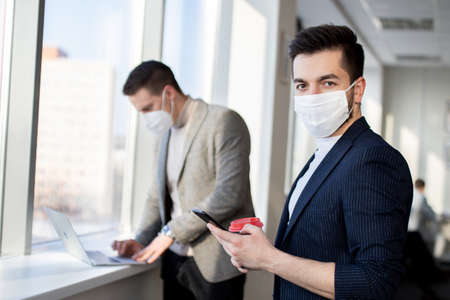 Businessmen wearing face masks are negotiating. New normal after virus pandemic.の写真素材