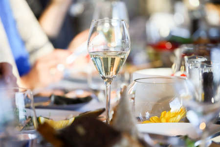 Glassware, glasses for white wine on a table in the restaurant. Banquet, cutlery, table setting.の写真素材