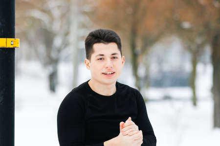MINSK. BELARUS - January 2021: The young man warms his hands in winter while doing sports.の写真素材