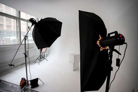 Photo studio, lighting fixtures, white endless background, white cubes. A professional studio equipment.の写真素材