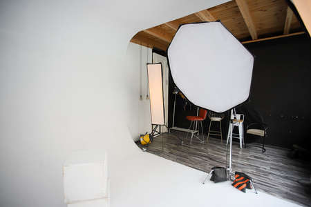 Orthobox and strip lights in a professional photo studio. Photo studio, lighting fixtures, white endless background, white cubes. Professional studio equipment. Photo studio, lighting fixtures, white endless background, white cubes. A professional studio equipment.の写真素材