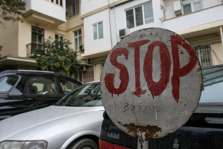 Azerbaijan, Baku - Nowember 2009: STOP road sign on a city street near residential buildings.のeditorial素材