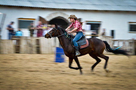 Belarus - 27,04,2013: rodeo, horses, horse races, golden spur. The girl rides a horse in a cowboy hat.のeditorial素材