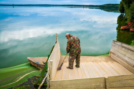 Belarus. August 2013: Workers in red overalls at a fish factory. Fish Farmingのeditorial素材