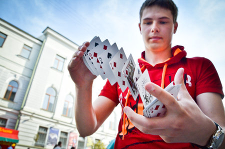 Belarus - 09,05,2013: Young man with playing cards. Cards, magic tricks, cheats, the deck of cards.のeditorial素材