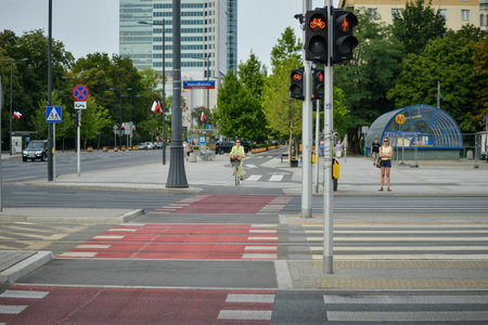 WARSAW. POLAND - August 2015: The pedestrian crossing button in the center of Warsaw with the word CAUTION. Against the background of a summer green park.のeditorial素材