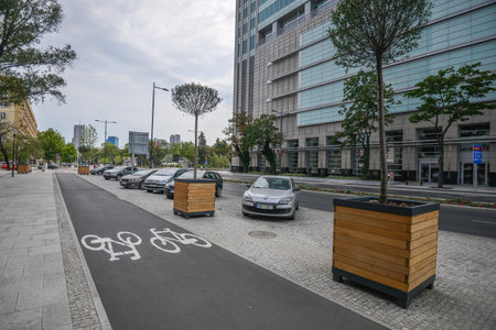 WARSAW. POLAND - AUGUST 2015: Cycle path near the car park on the background of the sky in the clouds. Summer in Warsaw.のeditorial素材