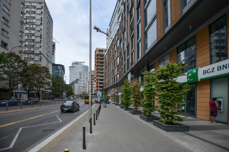 WARSAW. POLAND - AUGUST 2015: Cityscape of Warsaw in summer. Green trees along the road. Residential quarters, high-rise buildings. Warm summer day in Warsaw.のeditorial素材