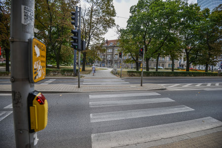 WARSAW. POLAND - August 2015: The pedestrian crossing button in the center of Warsaw with the word CAUTION. Against the background of a summer green park.のeditorial素材
