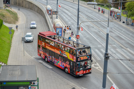 WARSAW. POLAND - August 2015: The double-decker tourist bus travels to the old town of Warsaw. The road through the old town.のeditorial素材