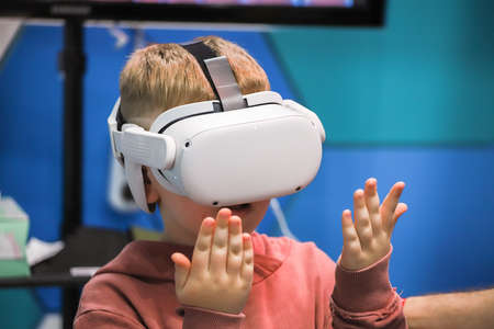 Boy holding his hands in front of virtual reality headset