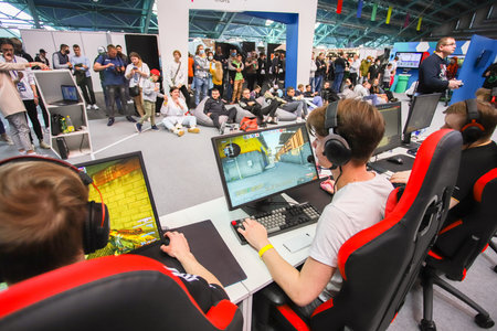 Belarus, Minsk -15.05.2021: Computer games, playground, young gamer plays computer games with headphones. Competitions.のeditorial素材