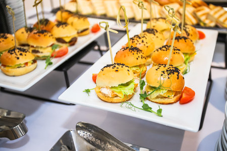 Burgers with cucumber and cheese, bun with a black sesame seeds on the food court.の写真素材