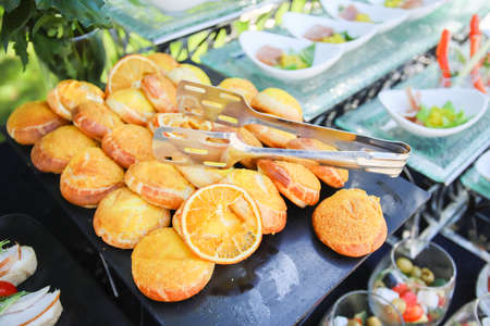 Minsk. Belarus - 18.06.2021 - Cookies with an orange. Buffet at a golf tournament.のeditorial素材