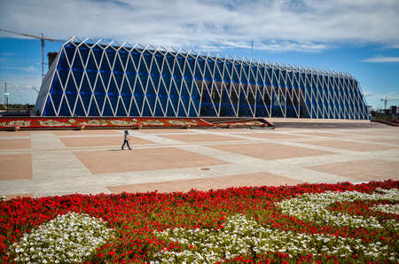 Nur-Sultan. Kazakhstan - 04.09.2013 - The new building of skyscraper against the blue sky. Glass windows and the sky in the clouds.のeditorial素材
