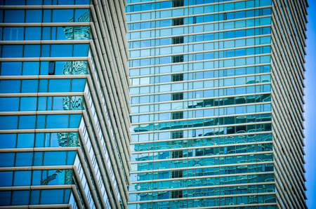 Close-up of windows in skyscrapers. Glass skyscrapers against the sky. Glass windows and the sky in the clouds.の写真素材