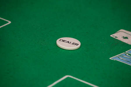 Minsk. Belarus - 25.06.2021 - Casino chips on a green gambling table. High quality photoのeditorial素材