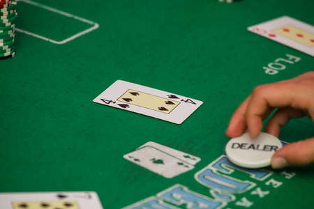 Minsk. Belarus - 25.06.2021 - Casino chips on a green gambling table. High quality photoのeditorial素材