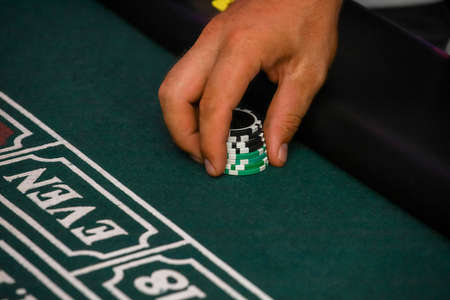 Minsk. Belarus - 25.06.2021 - Green gambling table in a casino. Playing cards for the casino. High quality photoのeditorial素材