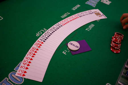 Minsk. Belarus - 25.06.2021 - Green gambling table in a casino. Playing cards for the casino. High quality photoのeditorial素材