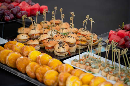 Mini burgers with black sesame seeds at the buffet table.の写真素材