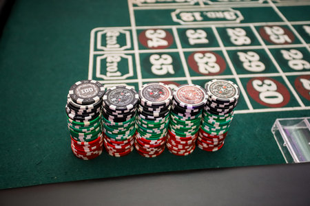Minsk. Belarus - 25.06.2021 - Playing chips from the casino on a roulette tableのeditorial素材