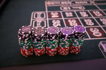 Minsk. Belarus - 25.06.2021 - Playing chips from the casino on a roulette tableのeditorial素材