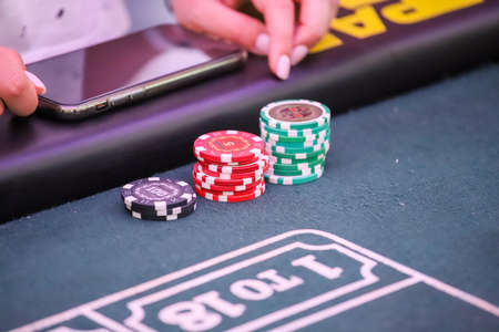 Minsk. Belarus - 25.06.2021 - Playing chips from the casino on a roulette tableのeditorial素材