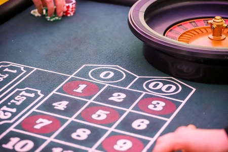Minsk. Belarus - 25.06.2021 - Chips on a casino playing table. Green table cover.