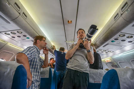 Switzerland - 05.29.2015 - Passengers and journalists on board, a blue seats, flight.のeditorial素材