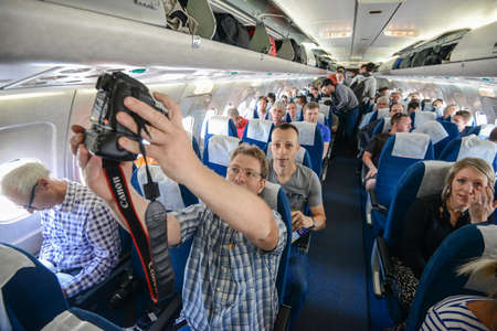 Switzerland - 05.29.2015 - Passengers and journalists on board, a blue seats, flight.のeditorial素材