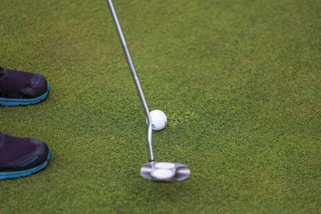 Minsk. Belarus - 25.07.2021 - Low section of man playing golf at driving range on a green fieldのeditorial素材
