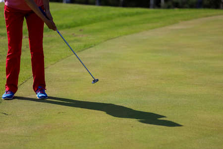 Minsk. Belarus - 24.07.2021 - Low section of man playing golf at driving range on a green fieldのeditorial素材
