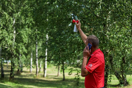 Minsk. Belarus- 25.07.2021 - Man signals the start of a golf tournament. High quality photoのeditorial素材
