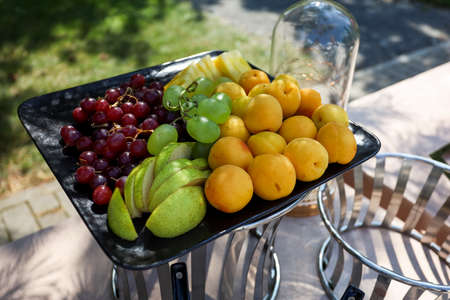 Fruit buffet in the square black tray.の写真素材
