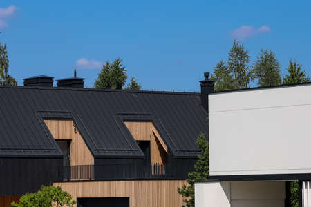 A modern family home with a trendy design. Gray roof, sand walls.の写真素材