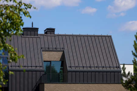 A modern family home with a trendy design. Gray roof, sand walls.の写真素材