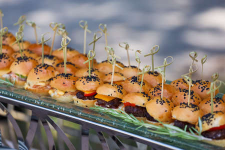 Mini burgers with black sesame seeds at the buffet table.の写真素材