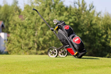 Minsk. Belarus - 25.07.2021 - Push-Pull Golf Carts on the field. Green grass, trees. High quality photoの写真素材