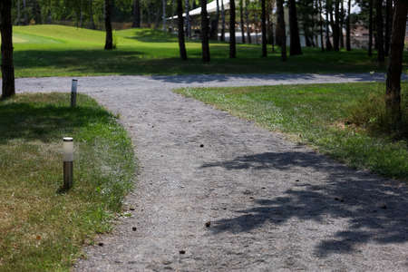 Dirt path in the park, lanterns on the sidesの写真素材