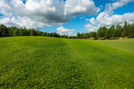 Panorama view of a Golf Course with fairway field. Golf course with a rich green turf beautiful scenery. High quality photoの写真素材