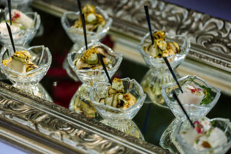 Appetizers, catering, snacks in glassware on the silver tray. High quality photoの写真素材