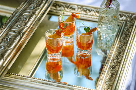 Appetizers, catering, snacks in glassware on the silver tray. High quality photoの写真素材