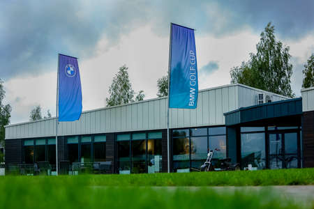 Belarus. Minsk - 21.08.2021 - BMW golf club, entrance to a building with panoramic windows, BMW advertising flagsのeditorial素材