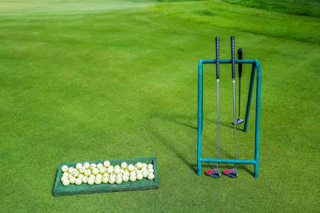 Golf ball on a green grass ready to be struck on golf course background. High quality photoの写真素材